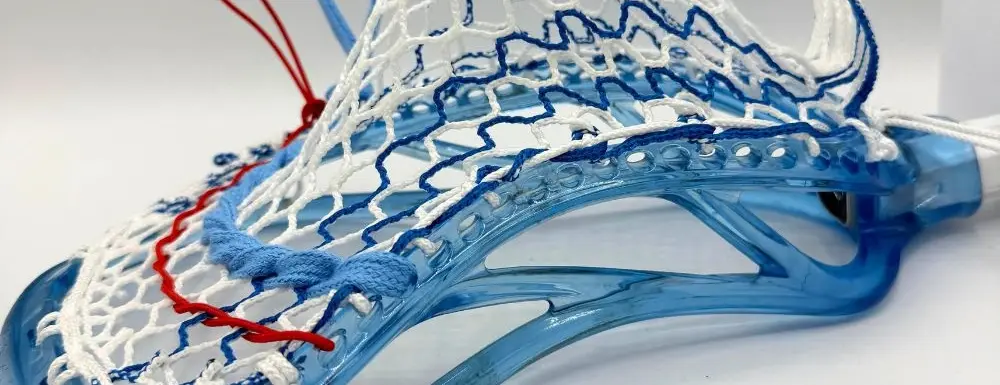 Lacrosse head with intricate stringing design.