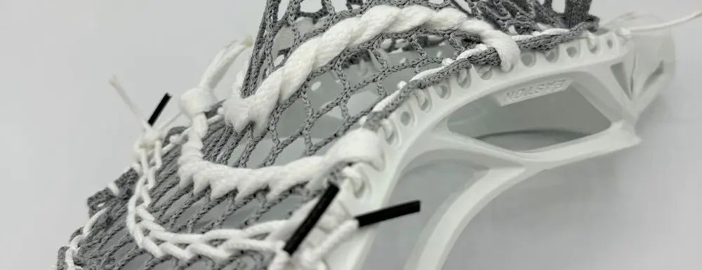 Lacrosse head with intricate mesh pocket