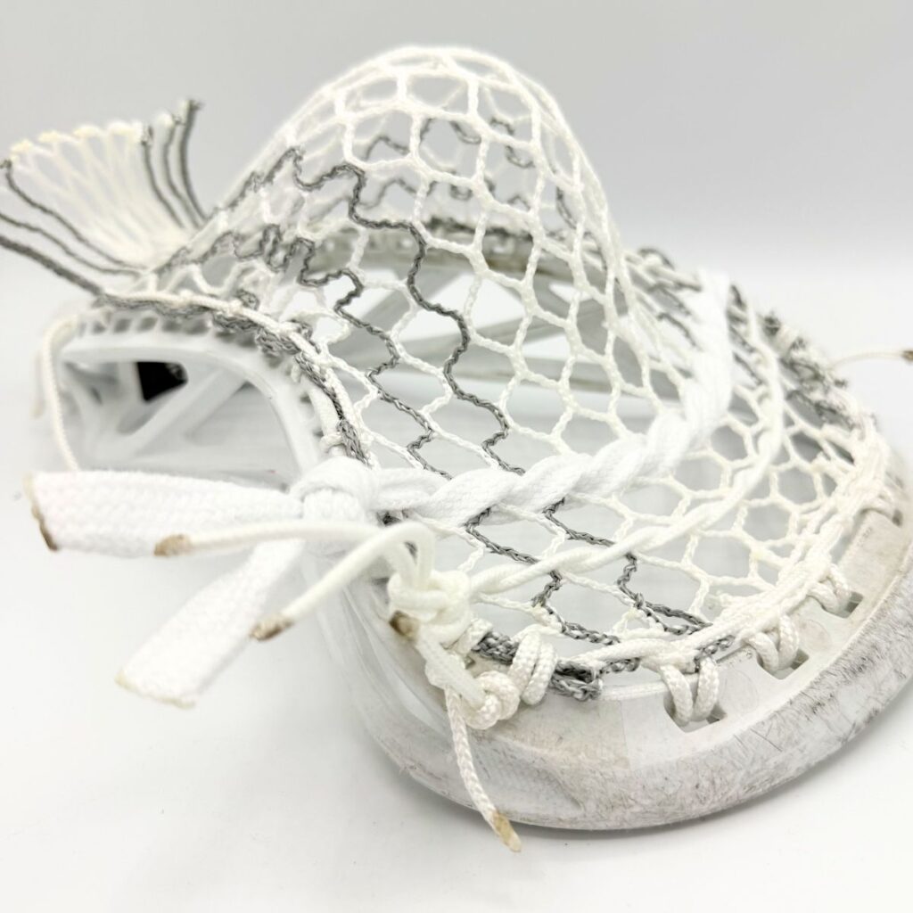 Close-up of Hero 4.0 Semi-Soft Grey Storm Striker mesh in an ECD Delta head, showcasing the weather-resistant weave and grey striker stripes.