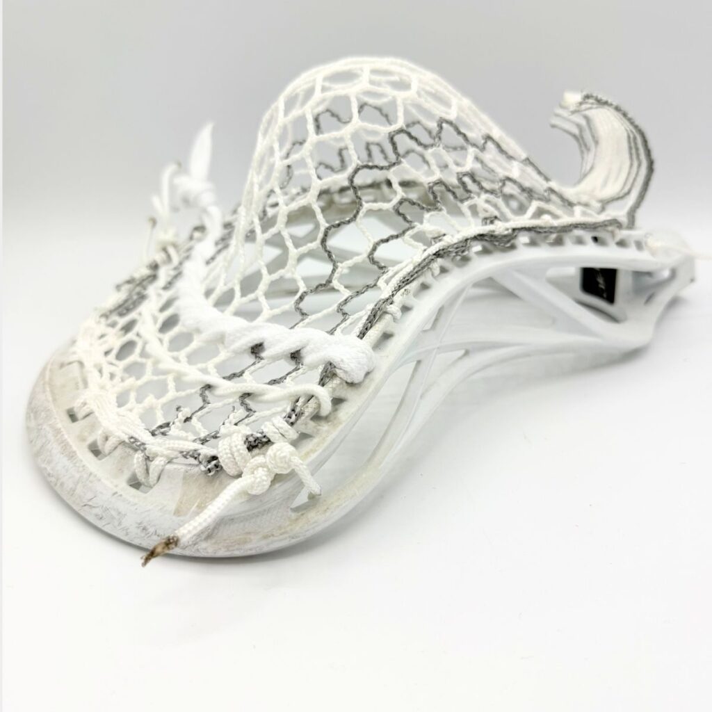 ECD Delta defensive lacrosse head featuring a mid-high pocket with Hero 4.0 Semi-Soft Grey Storm Striker mesh and dual-stripe accents.