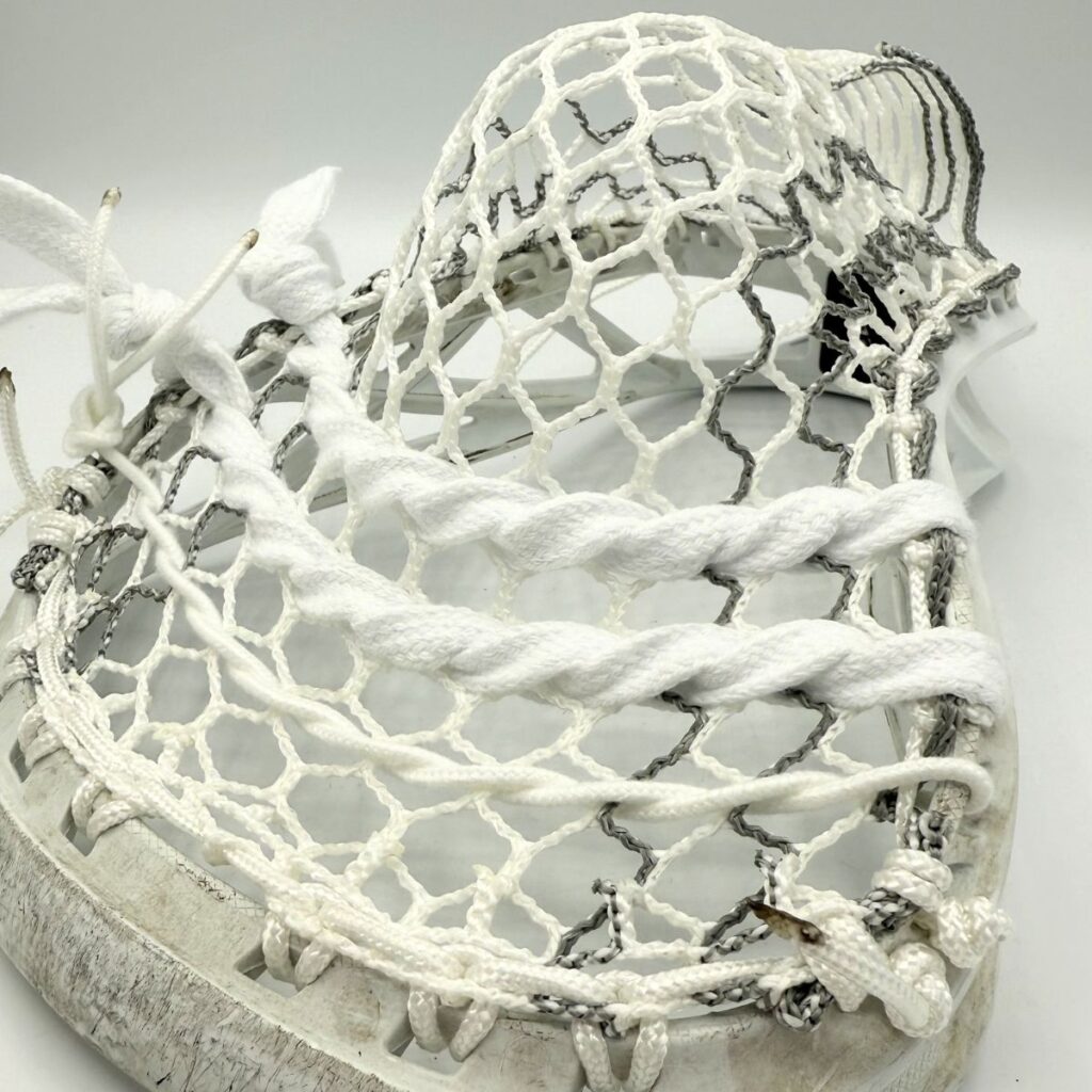 Close-up of Hero 4.0 Semi-Soft Grey Storm Striker mesh in an ECD Delta head, showcasing the weather-resistant weave and grey striker stripes.