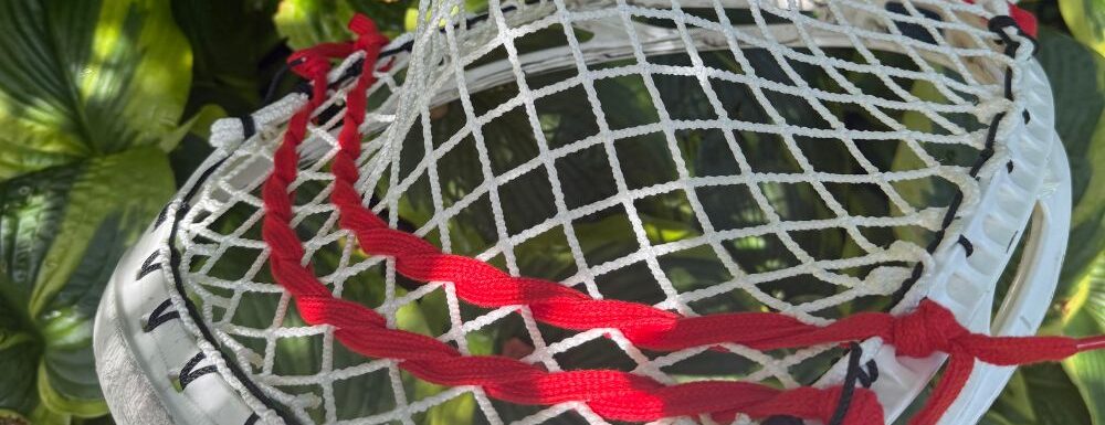 Goalie head with red and white mesh
