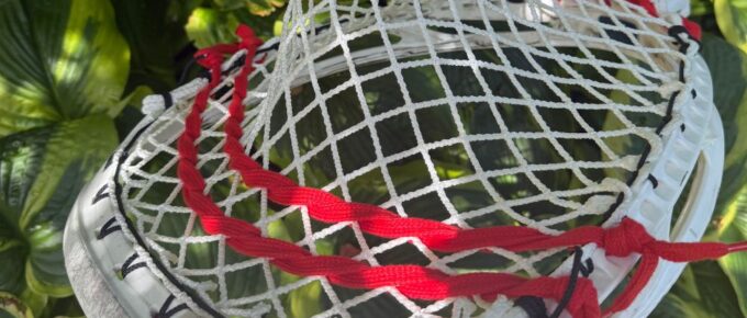 Goalie head with red and white mesh