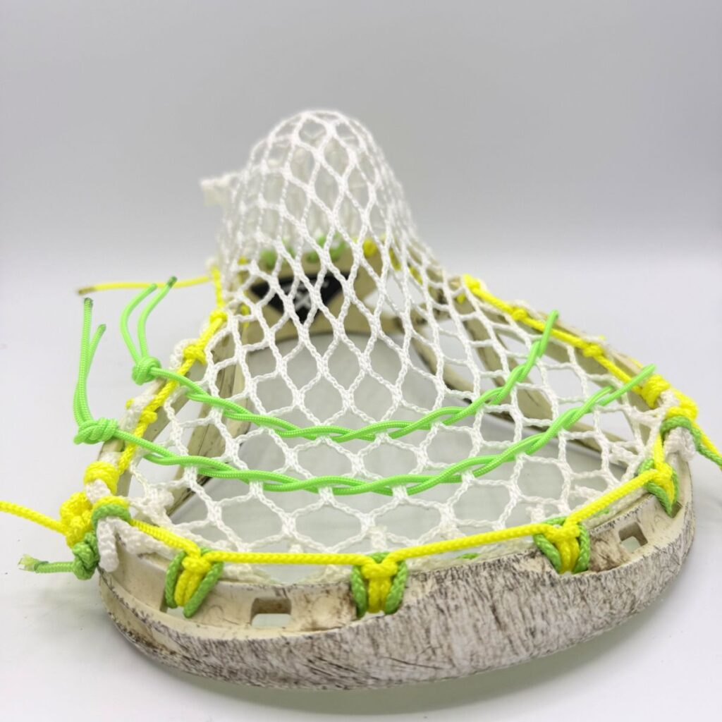 Channel on Custom strung ECD Weapon X lacrosse head featuring a mid-low pocket channel with white Hero X faceoff mesh.