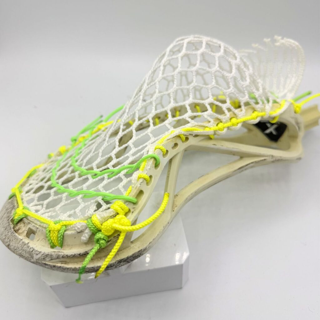 Side profile on Custom strung ECD Weapon X lacrosse head featuring a mid-low pocket channel with white Hero X faceoff mesh.