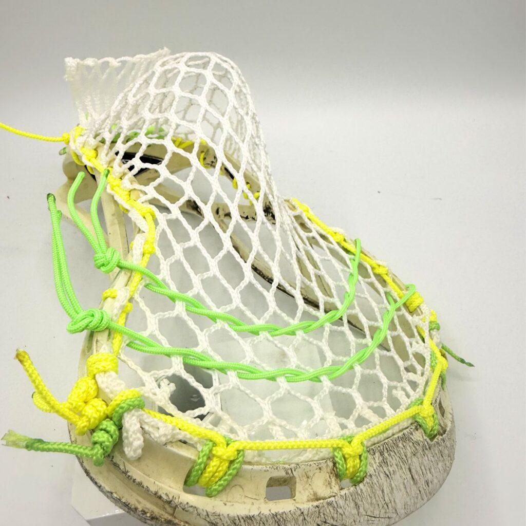 Channel angle on Custom strung ECD Weapon X lacrosse head featuring a mid-low pocket channel with white Hero X faceoff mesh.
