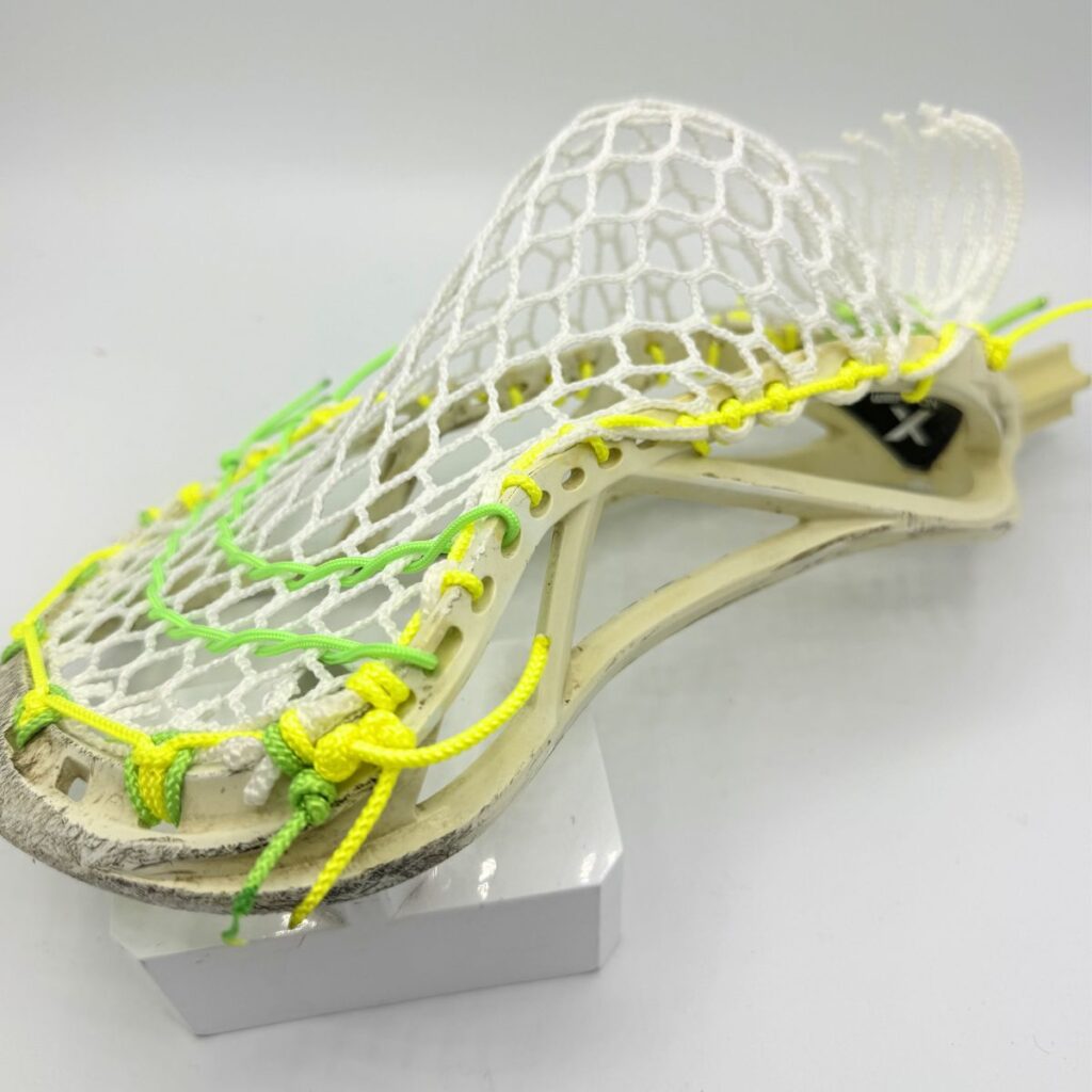 Side pocket on Custom strung ECD Weapon X lacrosse head featuring a mid-low pocket channel with white Hero X faceoff mesh.