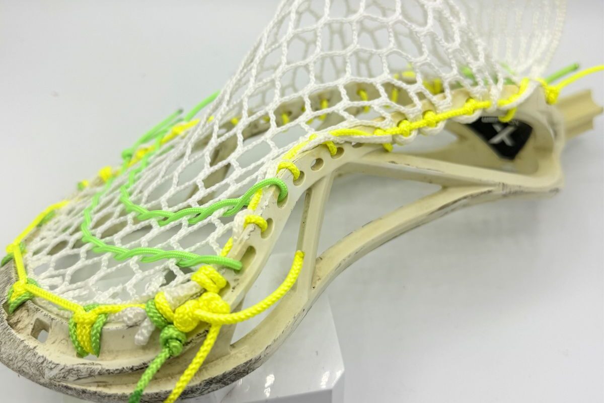 Custom strung ECD Weapon X lacrosse head featuring a mid-low pocket channel with white Hero X faceoff mesh.
