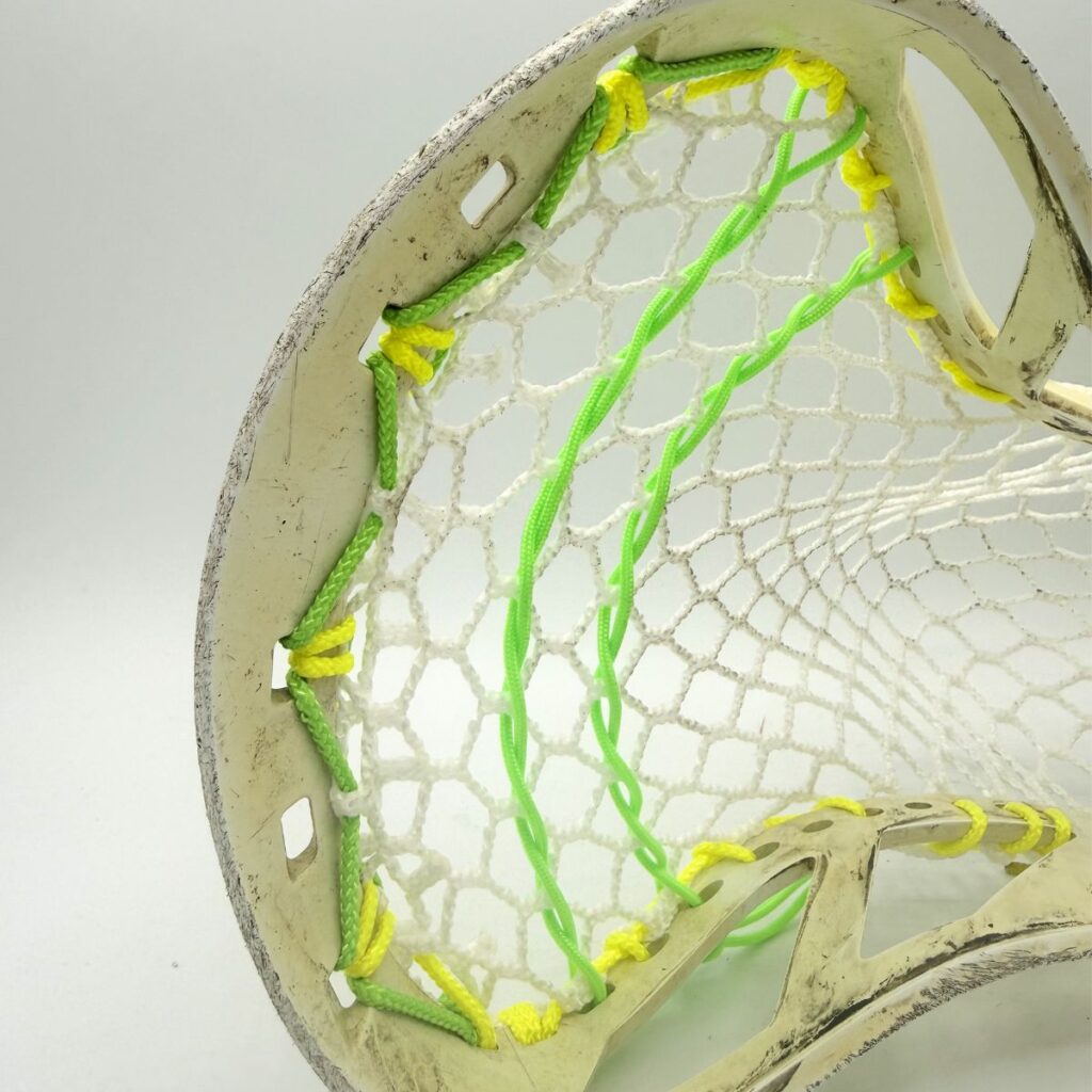 Triangle Top String on Custom strung ECD Weapon X lacrosse head featuring a mid-low pocket channel with white Hero X faceoff mesh.