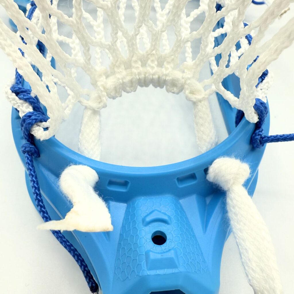 Maverik Optik Force lacrosse head - close up of throat and bottom string showing Hero 4 Semi-Soft mesh mid pocket channel