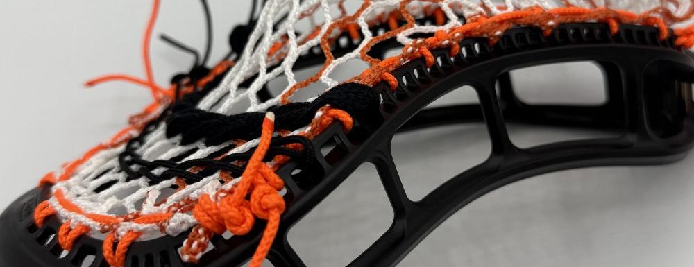 sidewall detail of stringking mark 3v with orange striker hero 3.0 semi-soft mesh