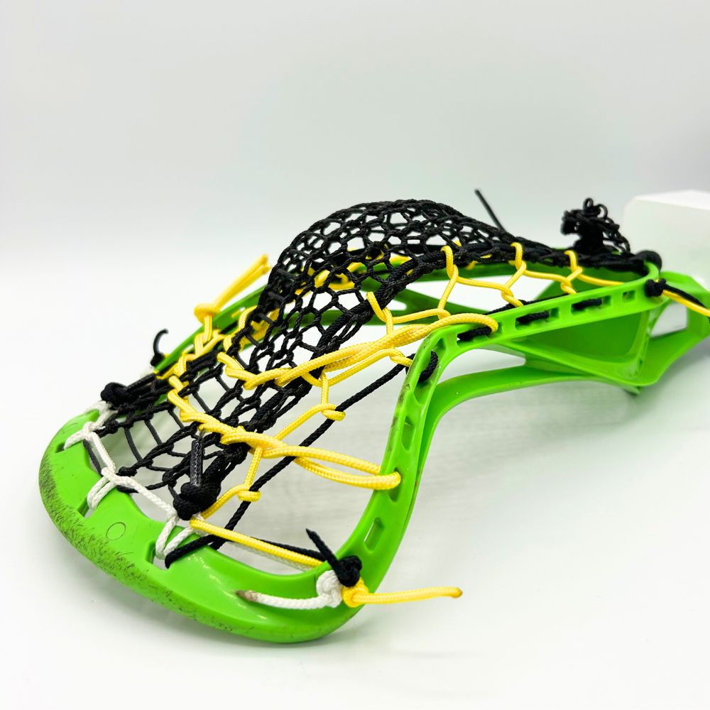 Close-up of a neon green STX Crux lacrosse head strung with a mid-hold, all-around pocket using a black Valkyrie Runner mesh