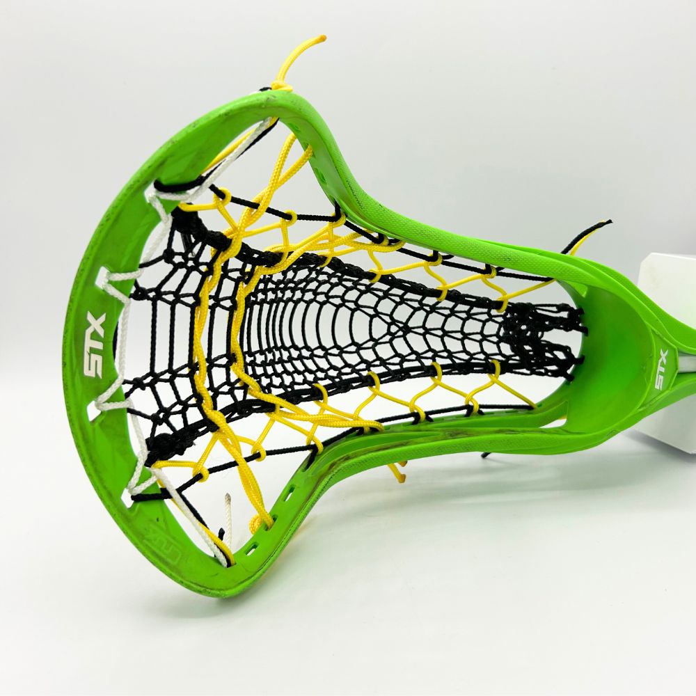 Close-up of a neon green STX Crux lacrosse head strung with a mid-hold, all-around pocket using a black Valkyrie Runner mesh