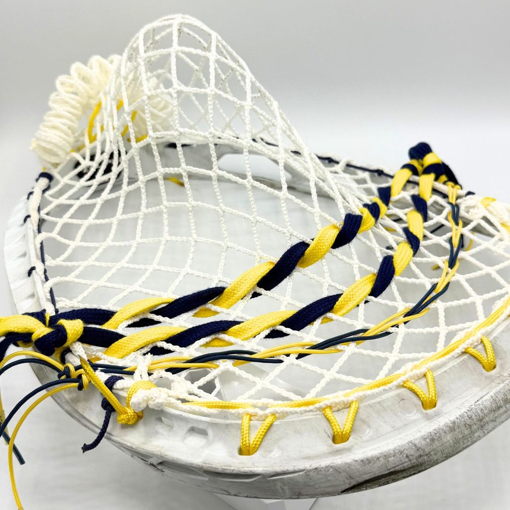 angled view of ecd impact 12d semisoft goalie pocket in an stx eclipse ii head with white top string and navy and yellow shooting strings