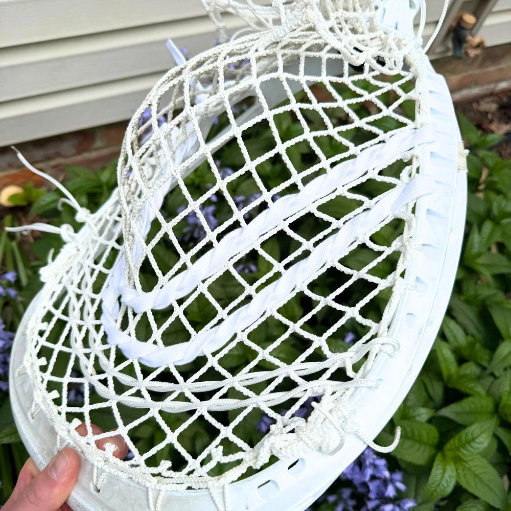 white STX Eclipse II lacrosse goalie head strung with white StringKing Grizzly 2 mesh, showing the pocket and stringing detail
