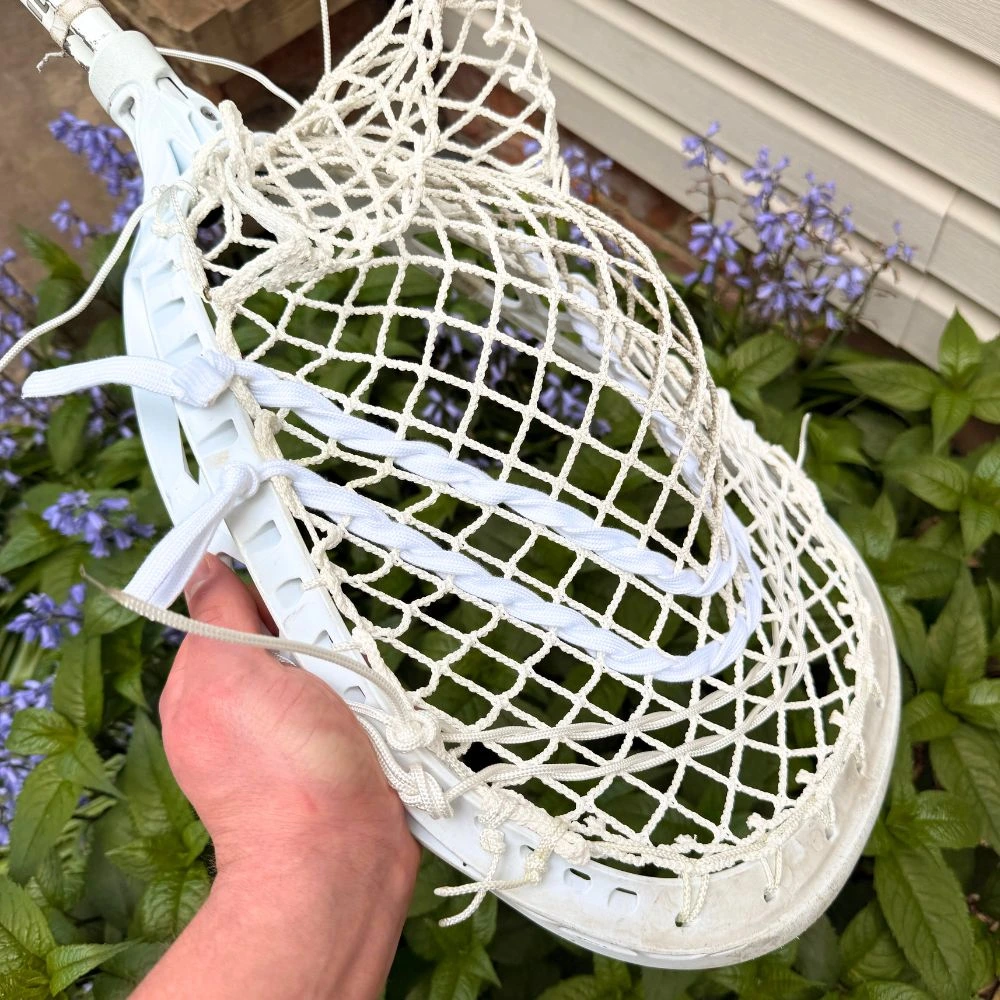 The white STX Eclipse II lacrosse goalie head, known for its face shape and stiffness, paired with the lightweight and responsive white StringKing Grizzly 2 goalie mesh