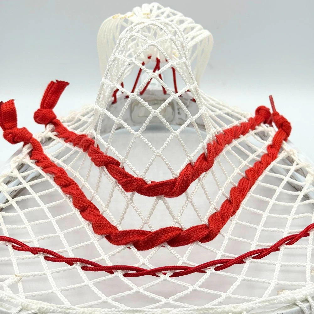 stx eclipse 3 lacrosse goalie head strung with white stringers shack g3 12d mesh, red shooting strings from laxroom, and red stringers shack bottom string and nylon. image features the channel