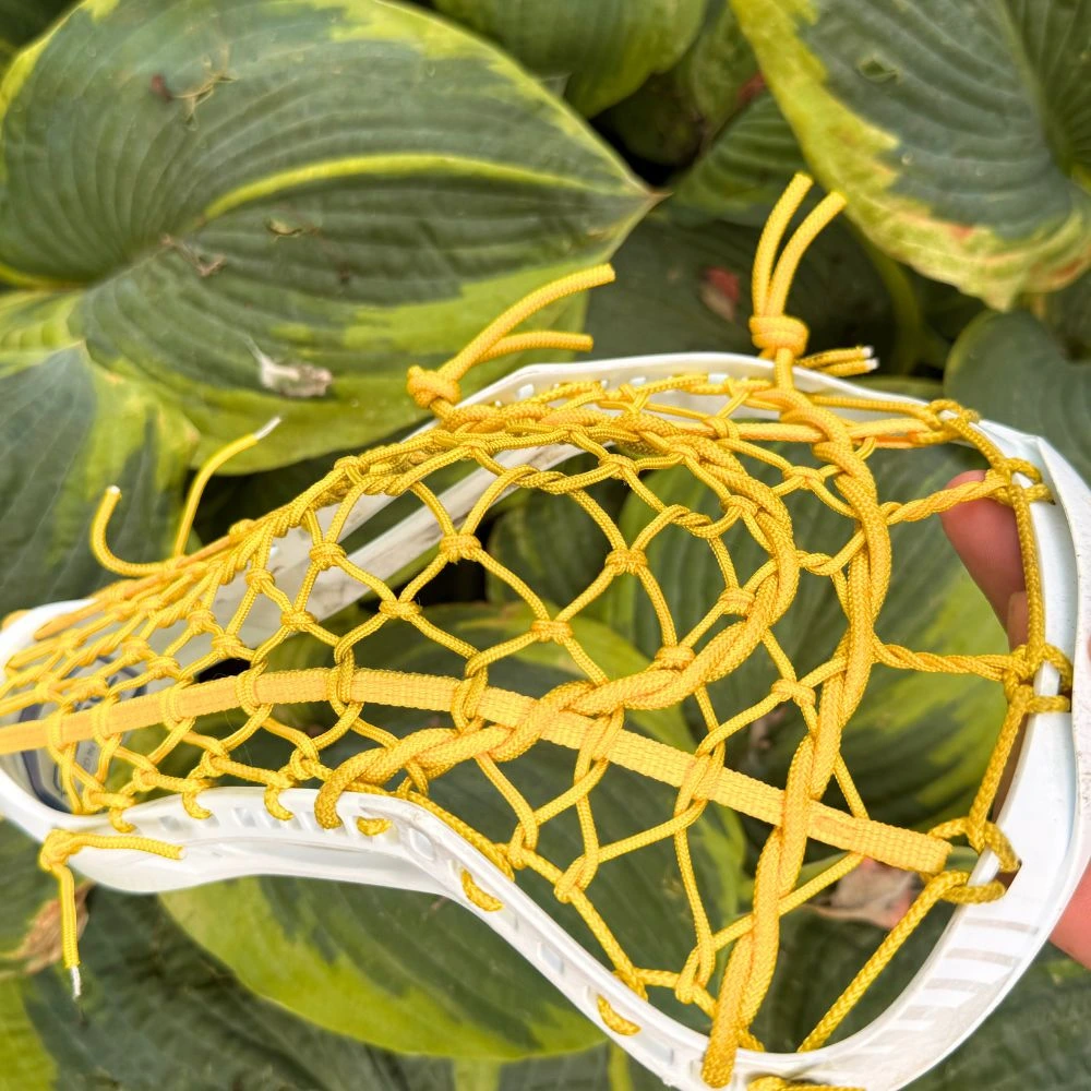 stx fuse with a broken in all yellow lock lacrosse pocket - left channel view