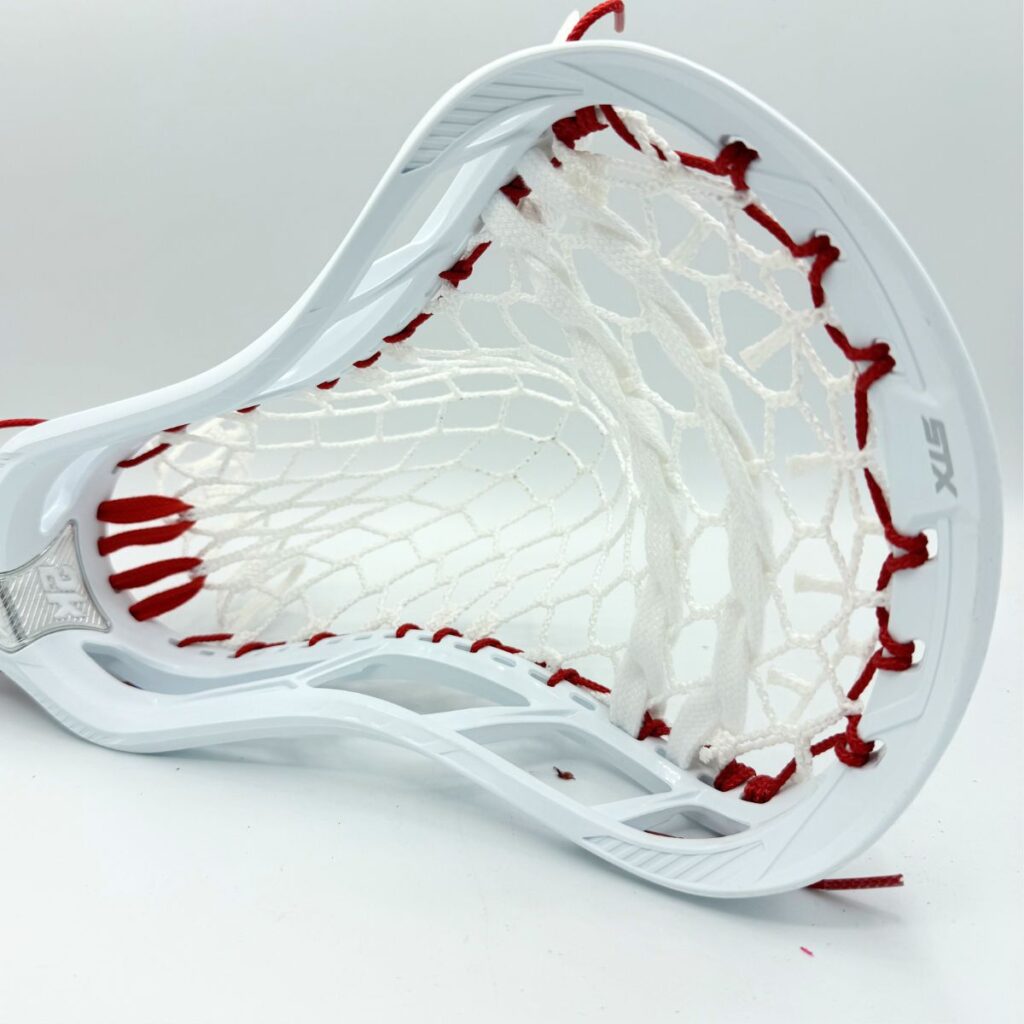 STX Magnet 2k lacrosse head with ECD Hero 4.0 7-diamond mesh — face-on view showing wide catching face and red sidewall stringing pattern