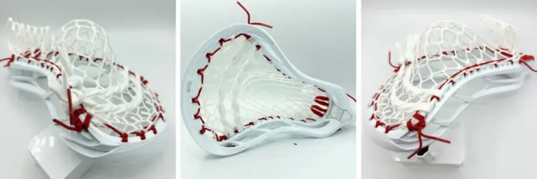 view of a custom-strung white STX magnet 2k lacrosse head on a white stand, featuring premium Hero 4.0 7-diamond mesh with striking red top and sidewall strings