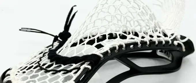 Lacrosse stick with white mesh pocket