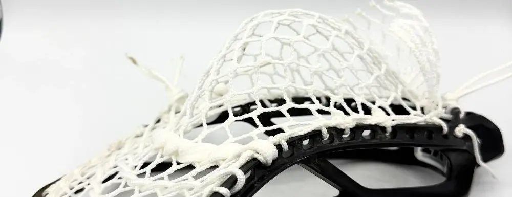 Lacrosse stick with white mesh pocket