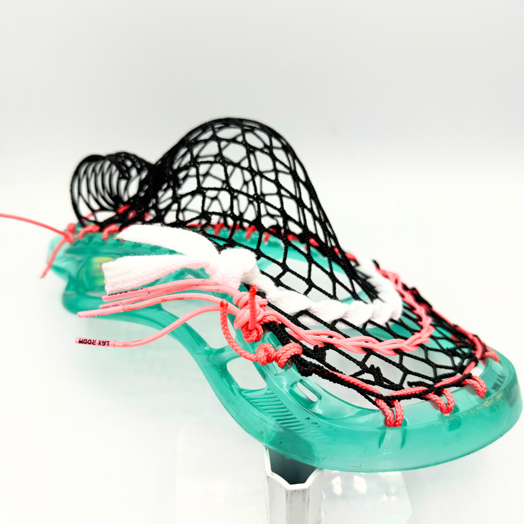 closeup of stx stallion prism sidewall with coral pink laxroom strings and black g3 xl mesh in a midfielder mid pocket