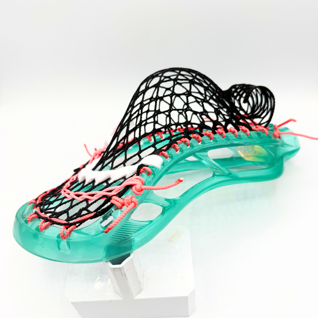 side profile of stx stallion prism head showing mid pocket depth with black g3 xl mesh and coral pink sidewall string