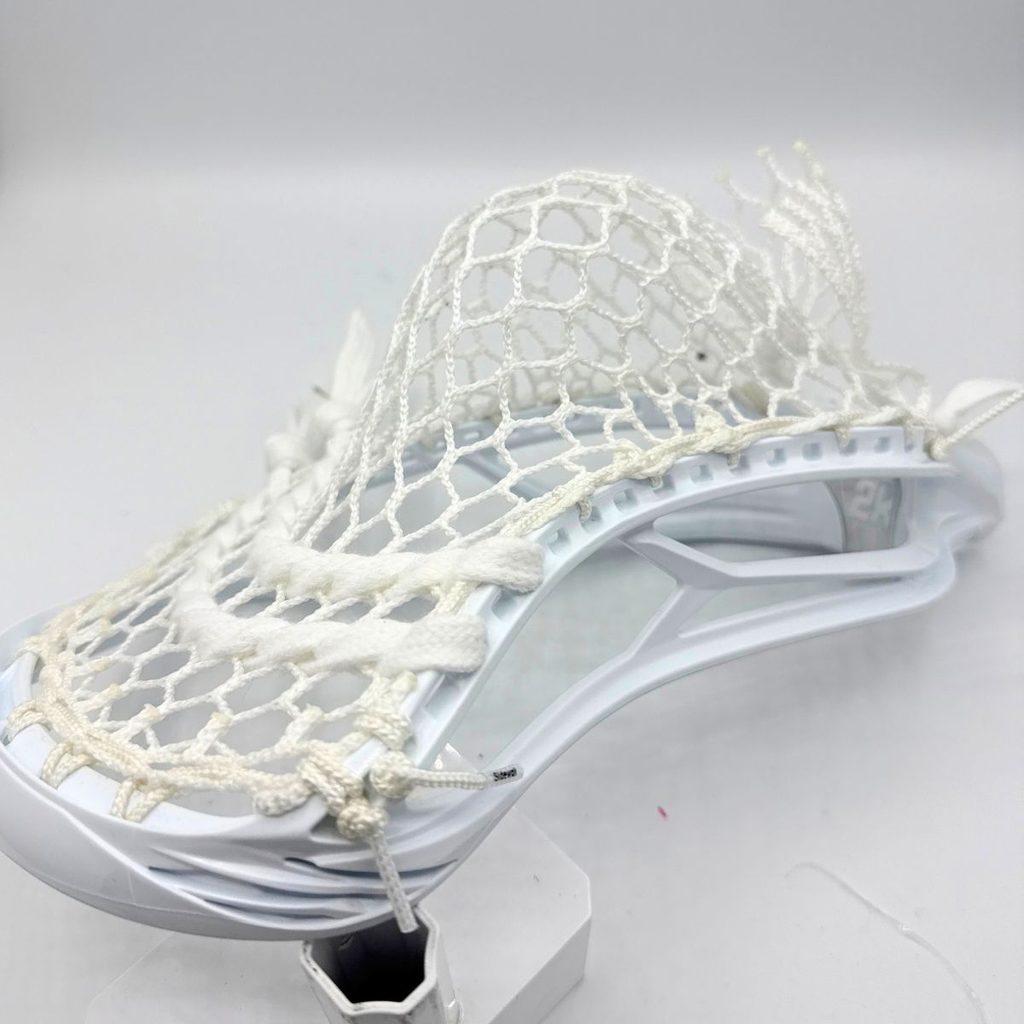 angled view of stx surgeon 2k on a stand with white ecd hero 4.0 semisoft mesh strung in a mid pocket