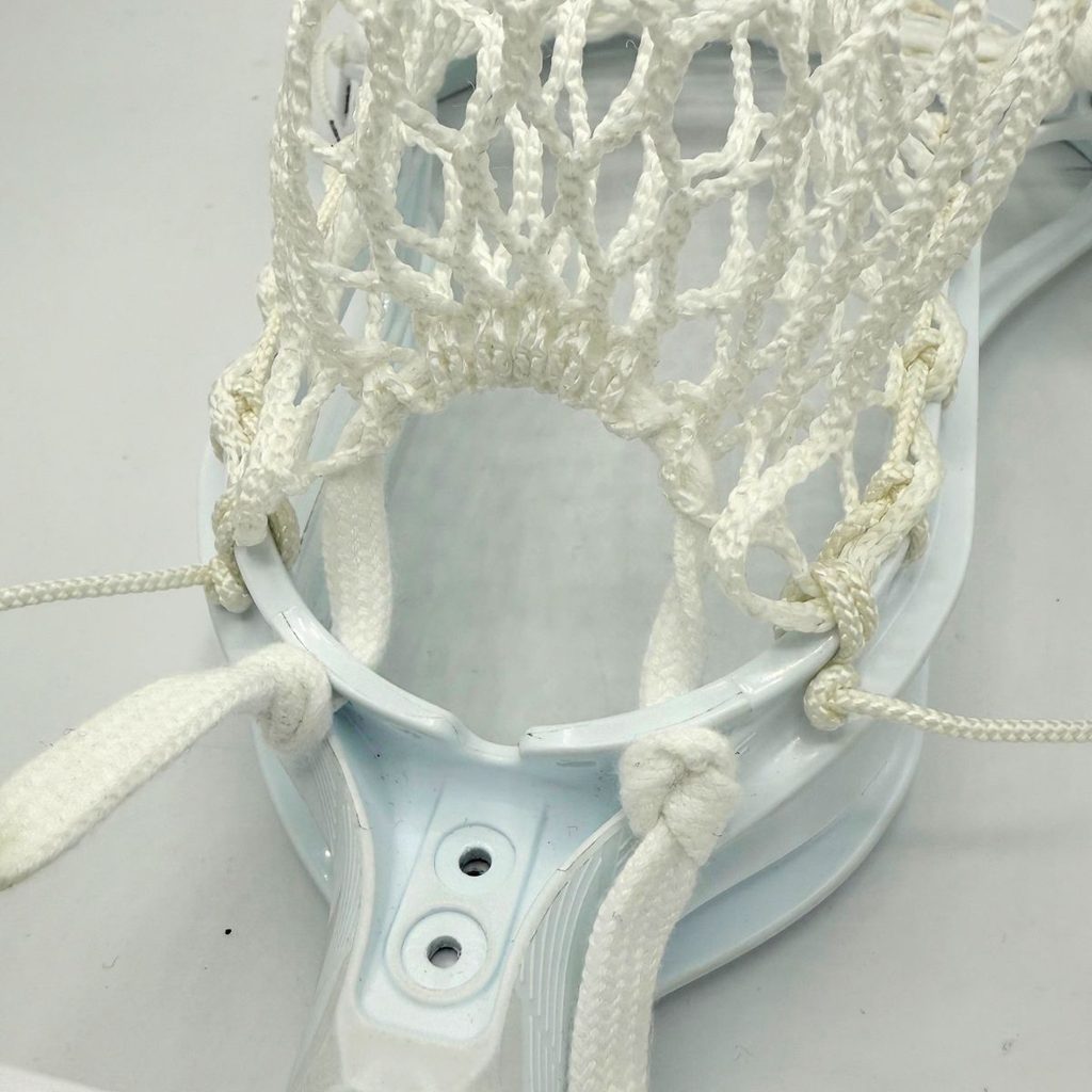 closeup of stx surgeon 2k throat showing white bottom string, lace shooter ties, and ecd hero 4.0 mesh
