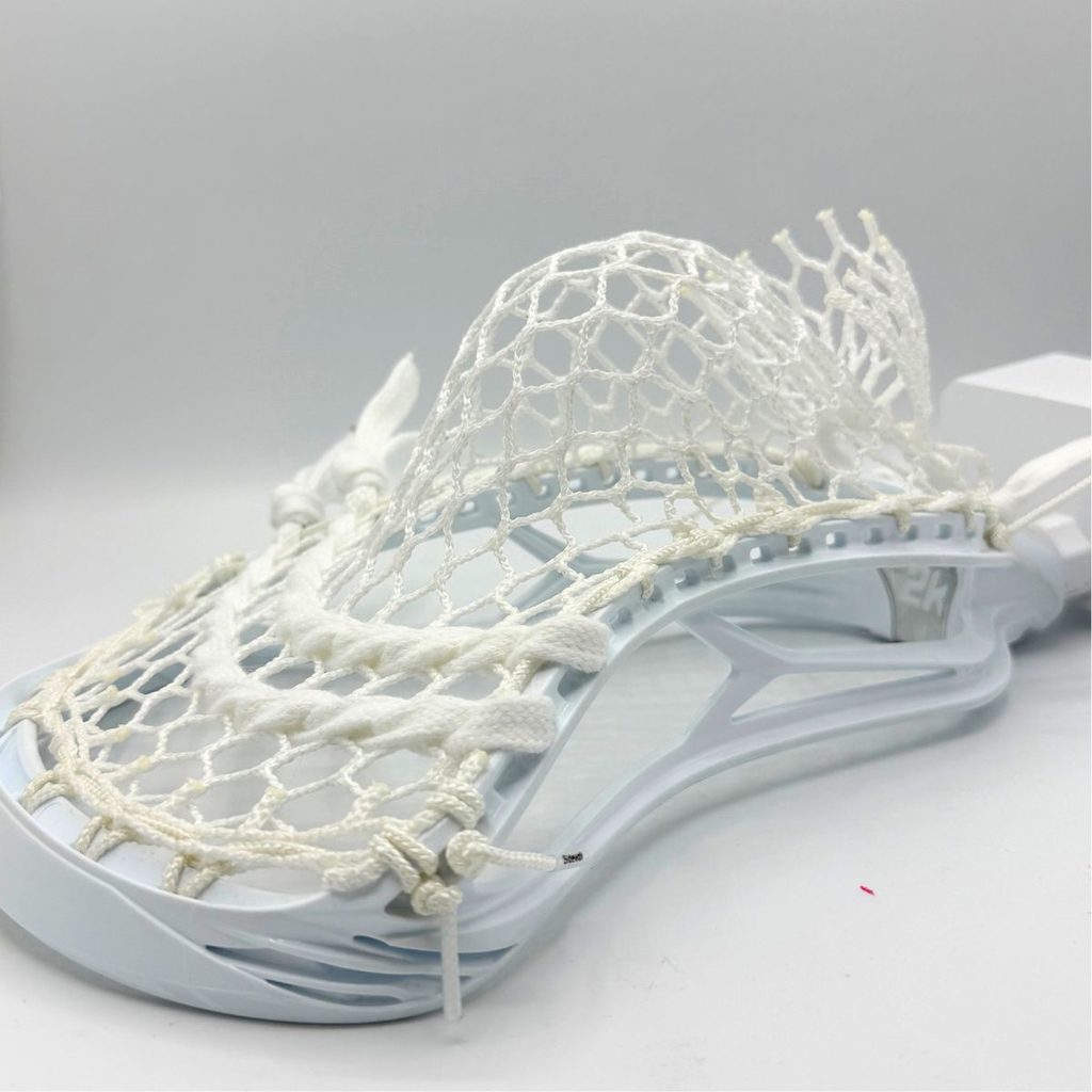 side profile of stx surgeon 2k showing mid pocket depth with white ecd hero 4.0 semisoft mesh and two lace shooters