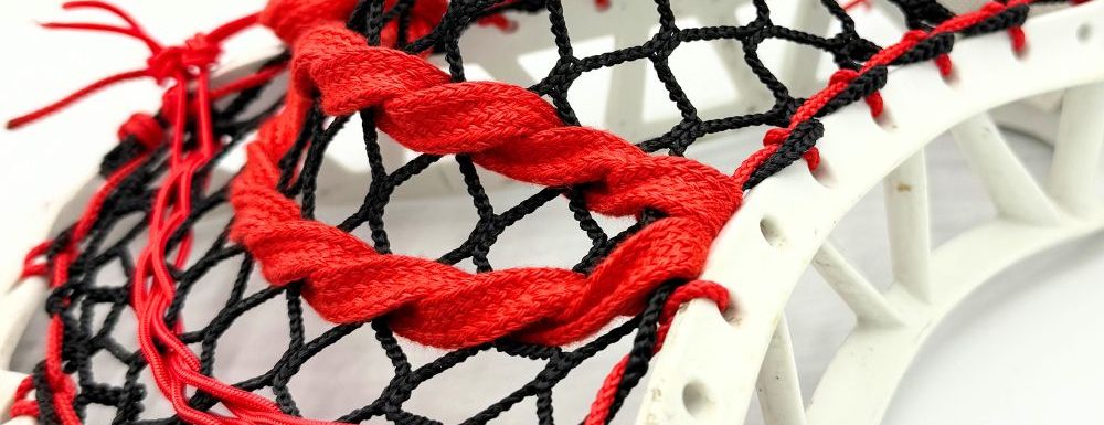 Lacrosse stick with red and black strings