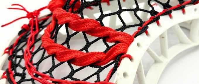 Lacrosse stick with red and black strings