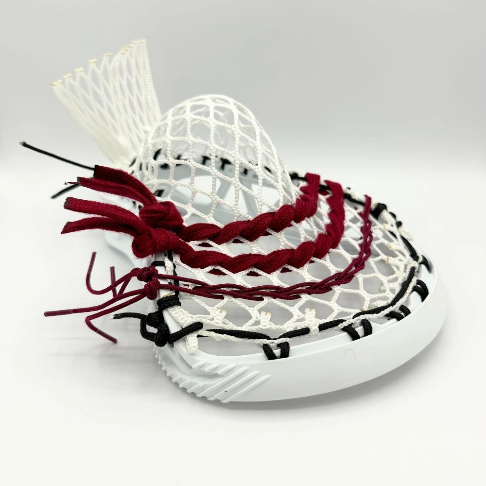 white stx x20 lacrosse head left channel view with stringers shack 10 diamond lacrosse mesh, a mid pocket, and maroon lacrosse shooting strings and cords