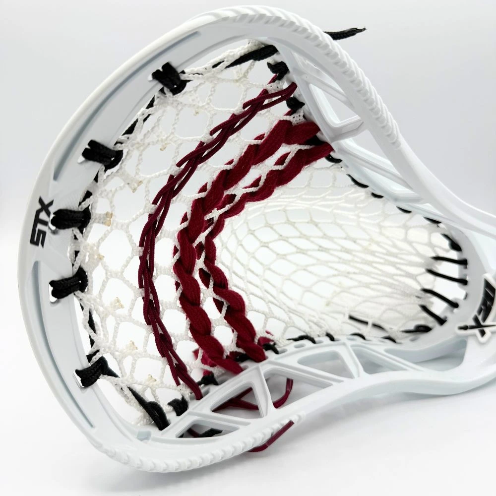 white stx x20 lacrosse head left channel view with stringers shack 10 diamond lacrosse mesh, a mid pocket, and maroon lacrosse shooting strings and cords