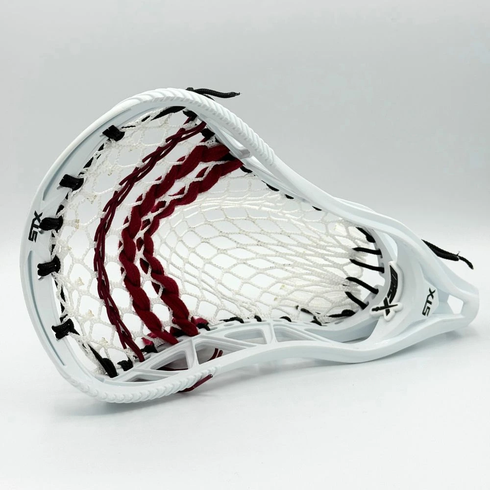 white stx x20 lacrosse head left face shape view with stringers shack 10 diamond lacrosse mesh, a mid pocket, and maroon lacrosse shooting strings and cords