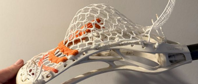 Lacrosse stick with white mesh pocket
