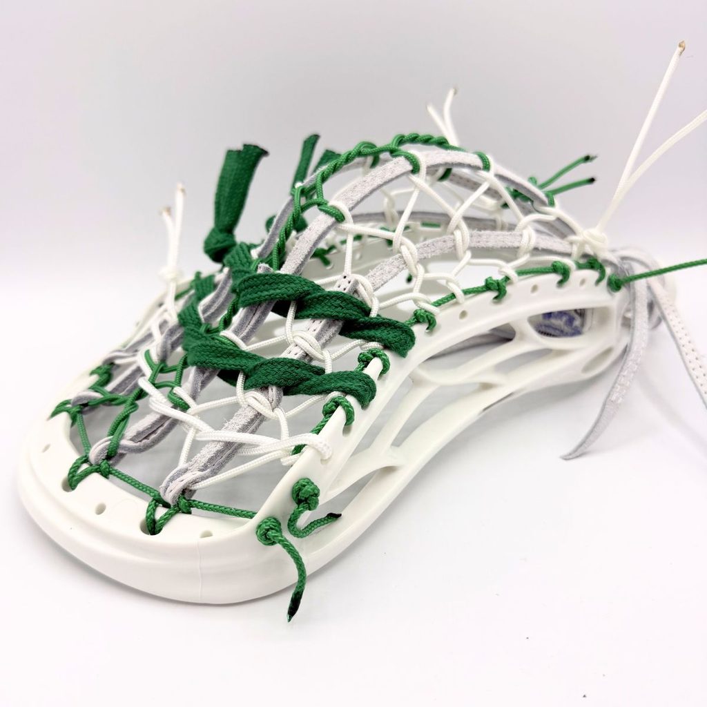 warrior revo ti lacrosse head strung with a traditional leather pita pocket, front channel view.