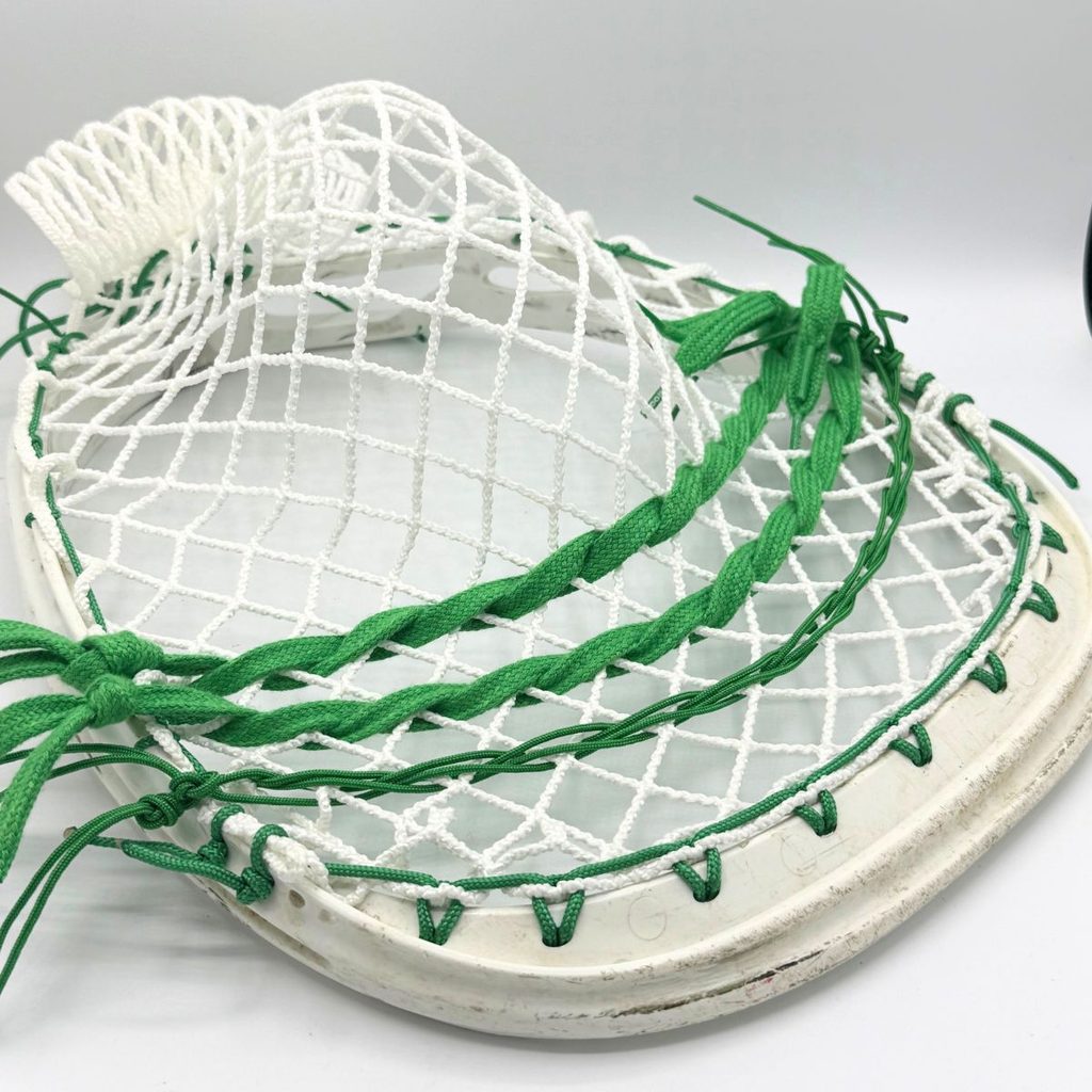 warrior void noz goalie head strung with white ecd impact 12d semihard mesh, green sidewall, green lace shooters and green nylons